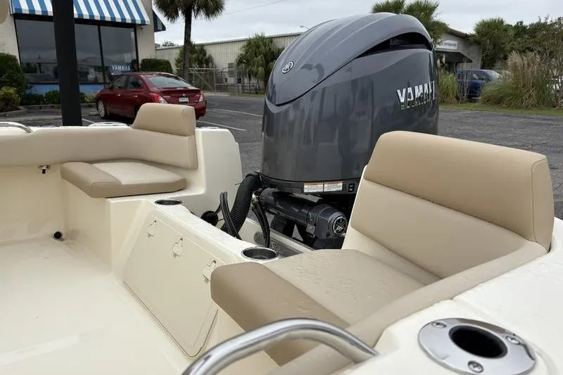 Slide: The Image of 2026 Scout 195 Sport Dorado boat on trailer, parked outdoors near a building. - 9