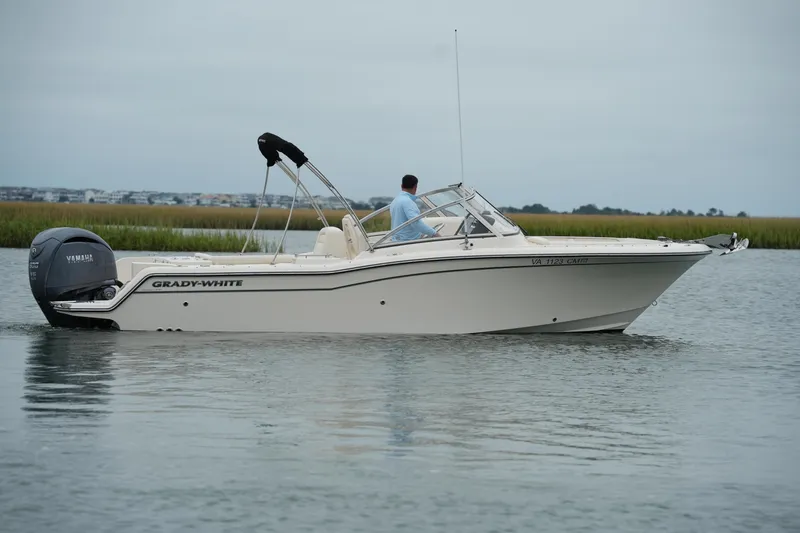 Slide: The Image of 2022 Grady-White Freedom 235 boat on calm water, side view. - 10