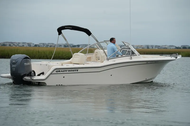 Slide: The Image of 2022 Grady-White Freedom 235 boat on water, side view with Yamaha engine. - 11