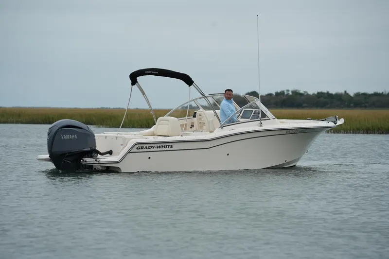 Slide: The Image of 2022 Grady-White Freedom 235 boat on calm water with Yamaha engine. - 12