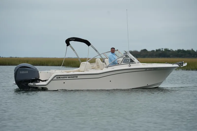 Slide: The Image of 2022 Grady-White Freedom 235 boat cruising on calm water with Yamaha engine. - 13