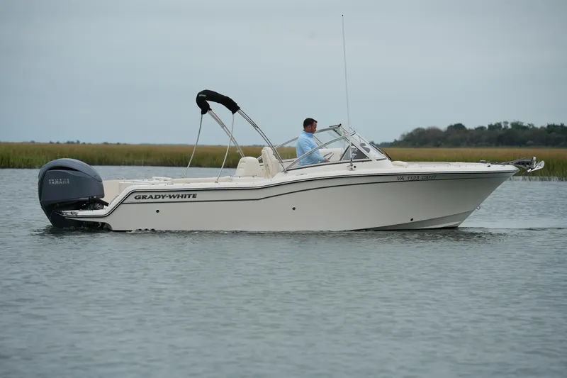 Slide: The Image of 2022 Grady-White Freedom 235 boat cruising on calm water. - 14