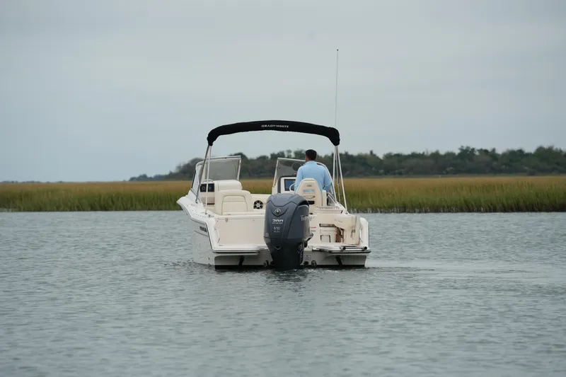 Slide: The Image of 2022 Grady-White Freedom 235 boat cruising on calm water. - 16