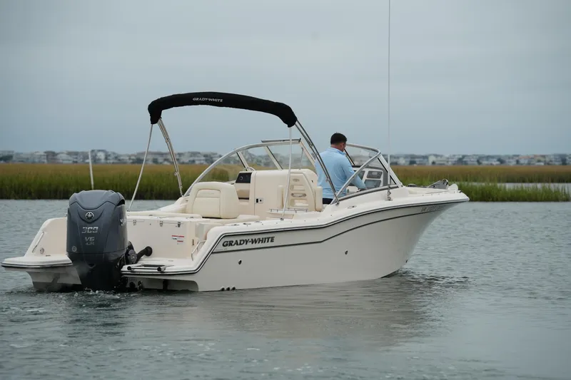 Slide: The Image of 2022 Grady-White Freedom 235 boat cruising on calm water. - 17