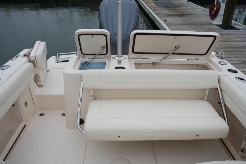 Slide: The Image of 2022 Grady-White Freedom 235 boat interior with open storage compartments and seating. - 20