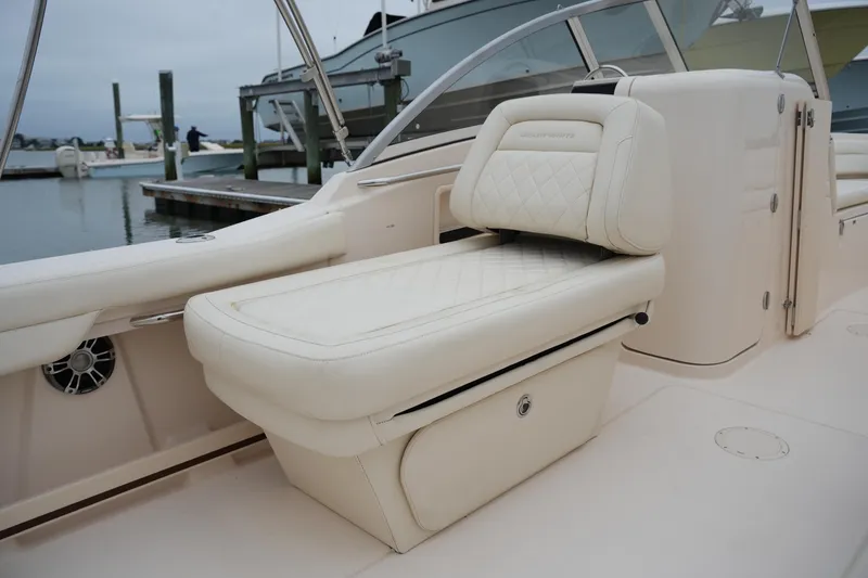 Slide: The Image of 2022 Grady-White Freedom 235 boat interior with luxurious cream seating and sleek design. - 22