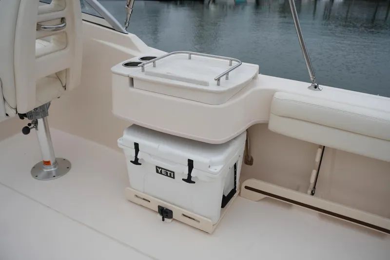 Slide: The Image of 2022 Grady-White Freedom 235 boat interior with Yeti cooler and seating area. - 23