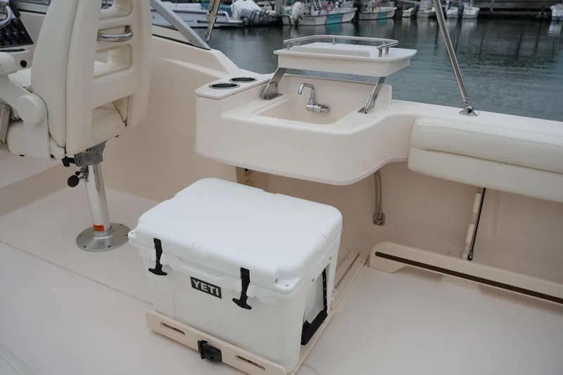 Slide: The Image of 2022 Grady-White Freedom 235 boat interior with sink and Yeti cooler. - 24