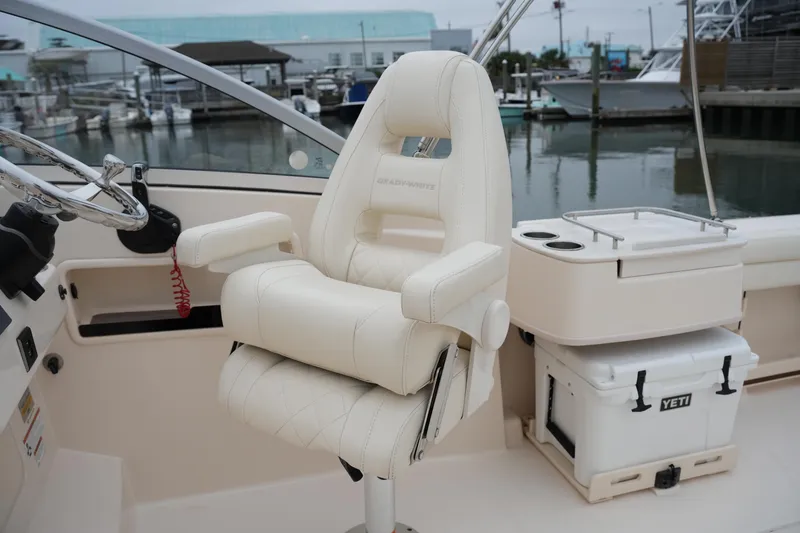 Slide: The Image of 2022 Grady-White Freedom 235 boat interior with helm seat and Yeti cooler. - 25