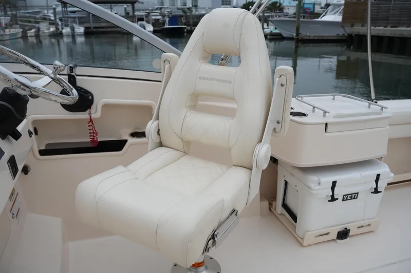 Slide: The Image of 2022 Grady-White Freedom 235 boat interior with captain's chair and Yeti cooler. - 26