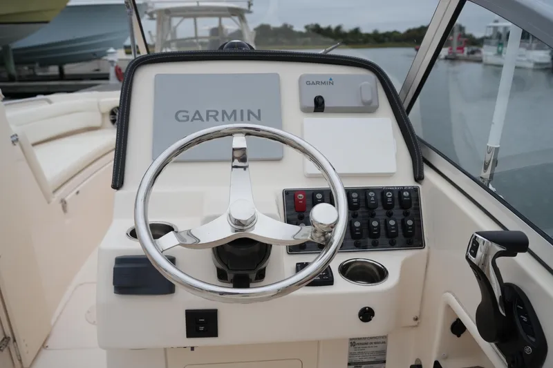 Slide: The Image of 2022 Grady-White Freedom 235 boat helm with Garmin navigation system and control panel. - 27