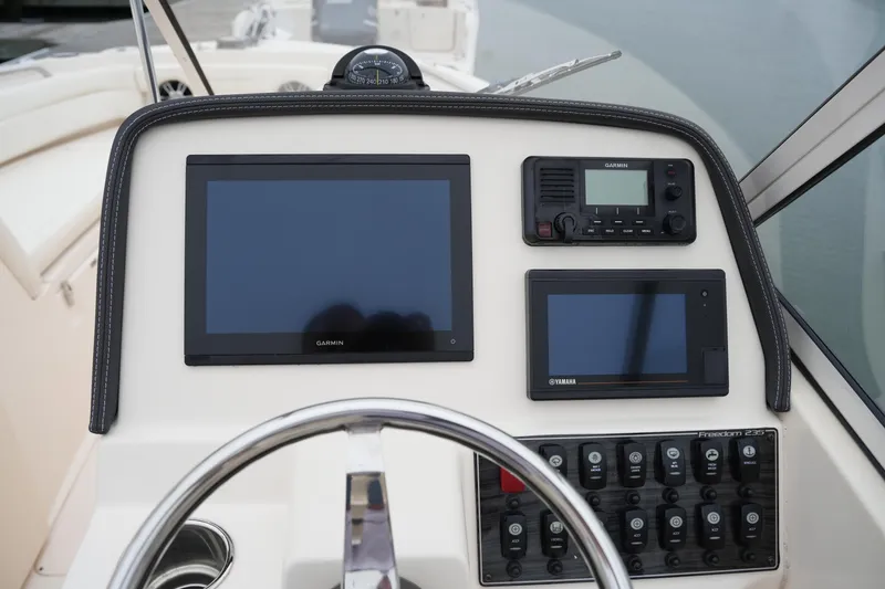 Slide: The Image of 2022 Grady-White Freedom 235 dashboard with Garmin and Yamaha displays. - 28