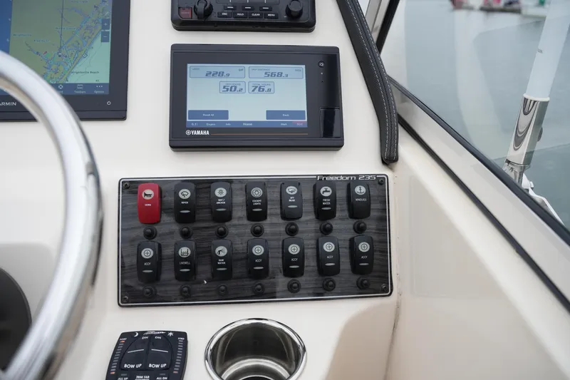Slide: The Image of Control panel of 2022 Grady-White Freedom 235 boat with Yamaha display and switches. - 31