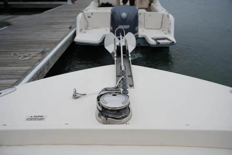 Slide: The Image of 2022 Grady-White Freedom 235 boat at dock, showing anchor and deck details. - 37