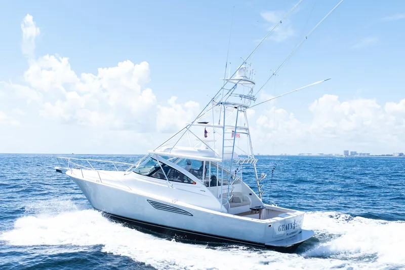 Slide: The Image of 2021 Viking 44 Open yacht cruising on the ocean under a clear blue sky. - 100