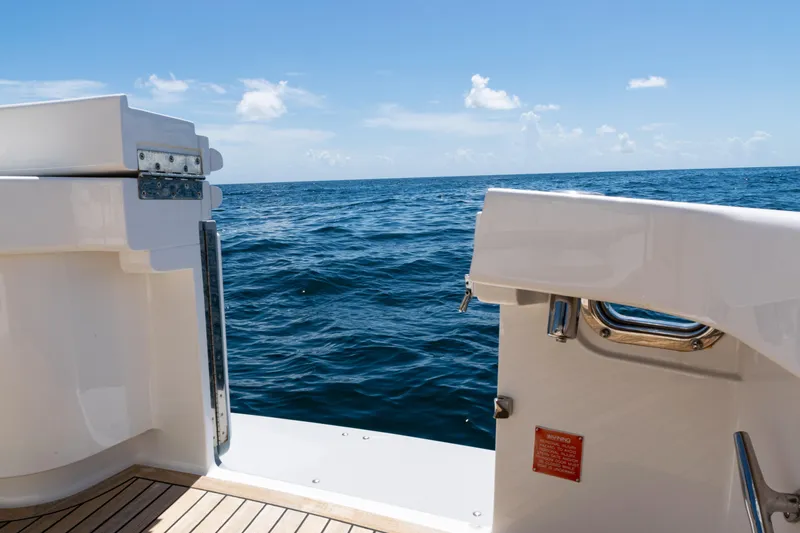 Slide: The Image of 2021 Viking 44 Open yacht deck with ocean view under clear blue sky. - 15