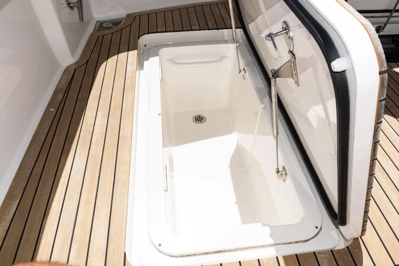 Slide: The Image of 2021 Viking 44 Open yacht storage compartment with teak flooring. - 18