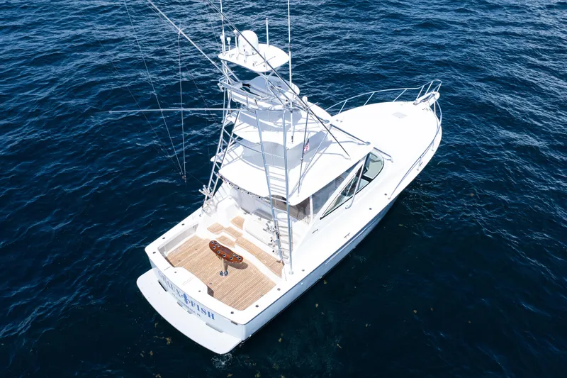 Slide: The Image of 2021 Viking 44 Open yacht on open sea, featuring sleek design and fishing tower. - 2