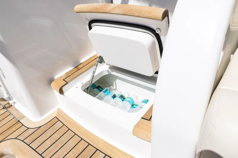 Slide: The Image of Built-in cooler with bottled water on 2021 Viking 44 Open yacht deck. - 20