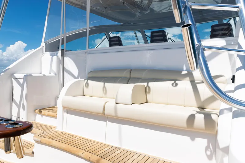 Slide: The Image of 2021 Viking 44 Open yacht interior with white seating and wooden deck. - 21