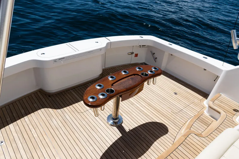 Slide: The Image of 2019 Viking 44 Open yacht deck with wooden table and ocean view. - 25