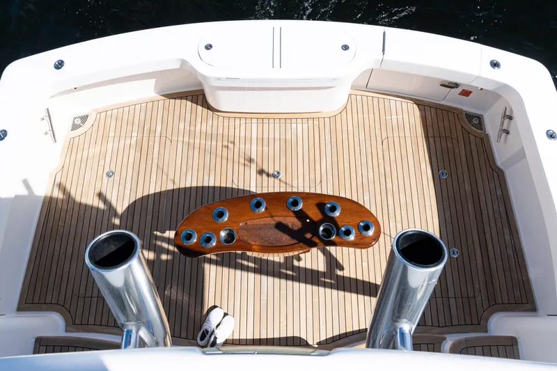 Slide: The Image of Cockpit of 2021 Viking 44 Open yacht with teak flooring and fishing rod holders. - 26
