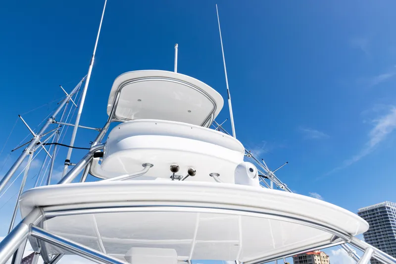 Slide: The Image of 2021 Viking 44 Open yacht against clear blue sky, showcasing sleek design and structure. - 31