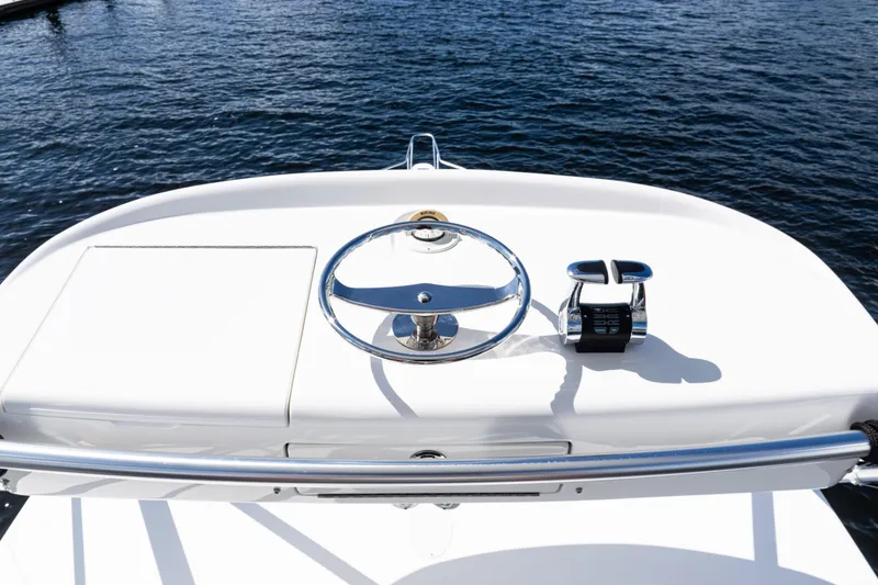 Slide: The Image of Steering console of 2021 Viking 44 Open yacht on calm water. - 40