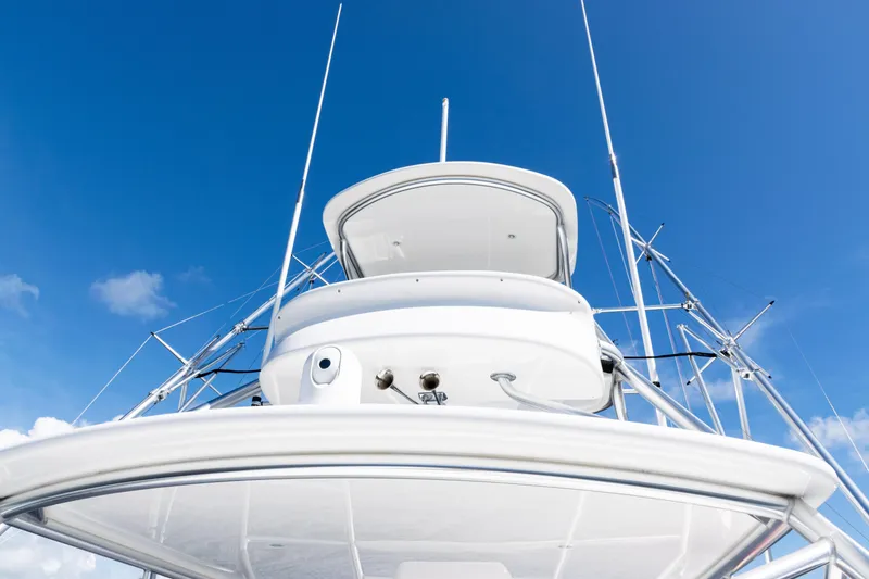 Slide: The Image of 2021 Viking 44 Open yacht against a clear blue sky, showcasing sleek design and structure. - 41