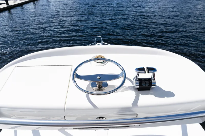 Slide: The Image of Steering wheel and controls of 2021 Viking 44 Open yacht on water. - 43