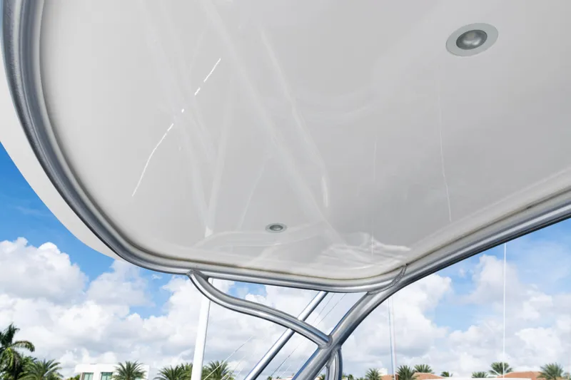 Slide: The Image of 2021 Viking 44 Open yacht canopy against blue sky and palm trees. - 45
