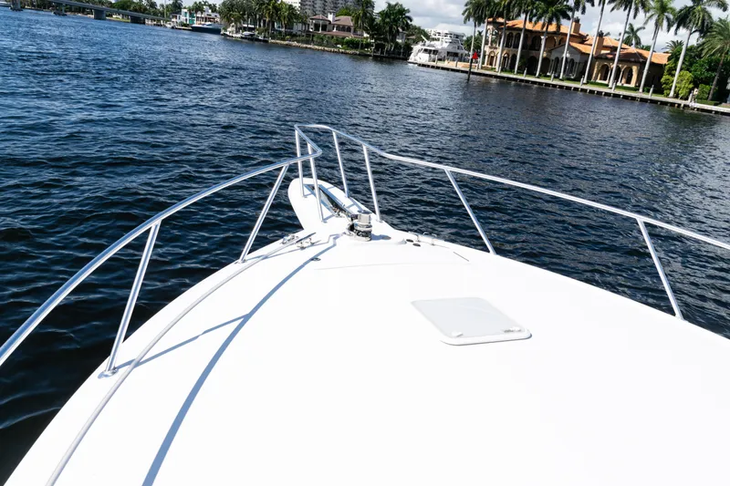 Slide: The Image of Bow view of 2021 Viking 44 Open yacht cruising on a scenic waterway. - 49