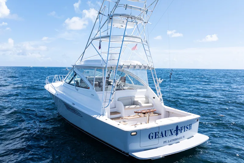 Slide: The Image of 2021 Viking 44 Open yacht on ocean, featuring sleek design and fishing tower. - 5