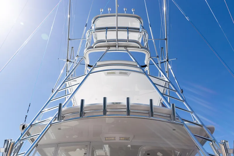 Slide: The Image of 2021 Viking 44 Open yacht tower against clear blue sky. - 51
