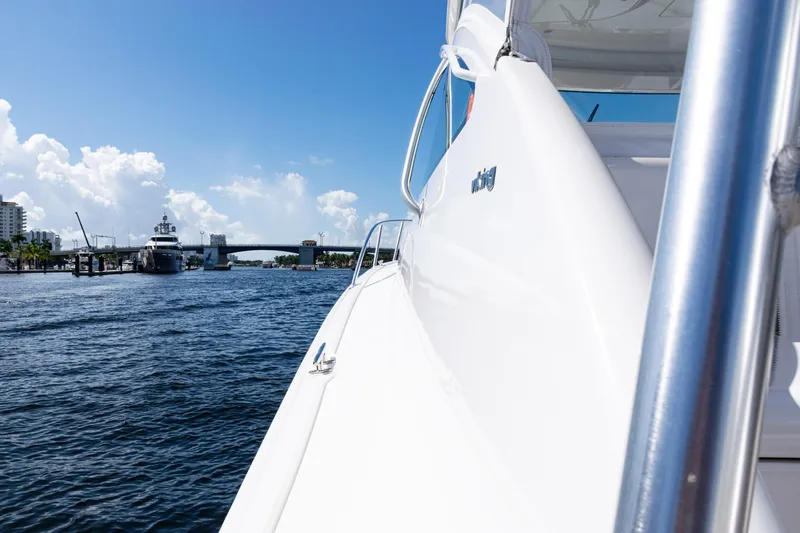 Slide: The Image of 2021 Viking 44 Open yacht cruising near a bridge on a sunny day. - 52