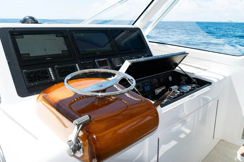 Slide: The Image of Helm of 2021 Viking 44 Open yacht with advanced navigation displays and controls. - 54