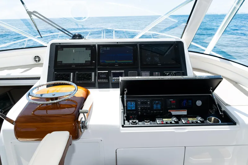 Slide: The Image of Cockpit of 2021 Viking 44 Open yacht with advanced navigation controls and ocean view. - 55