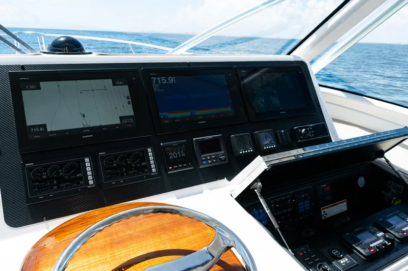 Slide: The Image of 2021 Viking 44 Open yacht helm with advanced navigation displays and controls. - 56