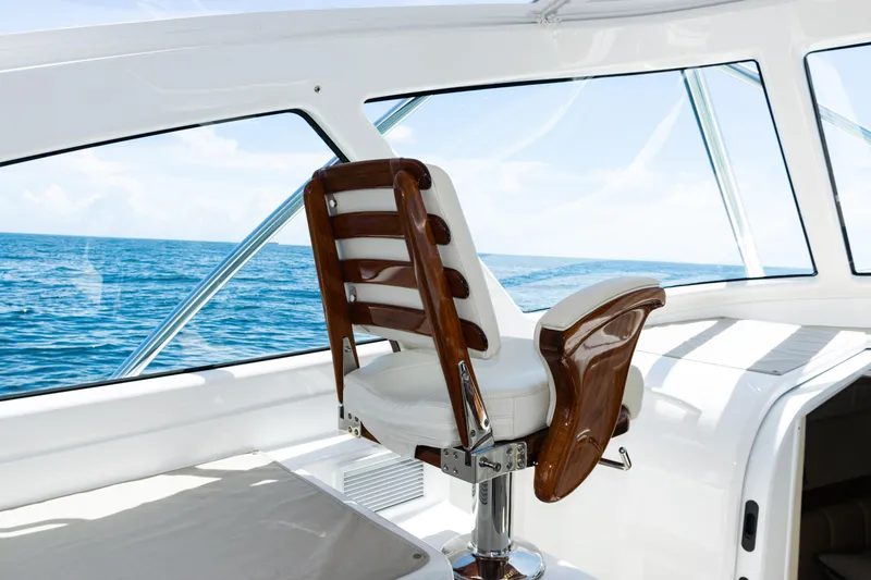 Slide: The Image of Captain's chair on 2021 Viking 44 Open yacht, overlooking the ocean. - 59