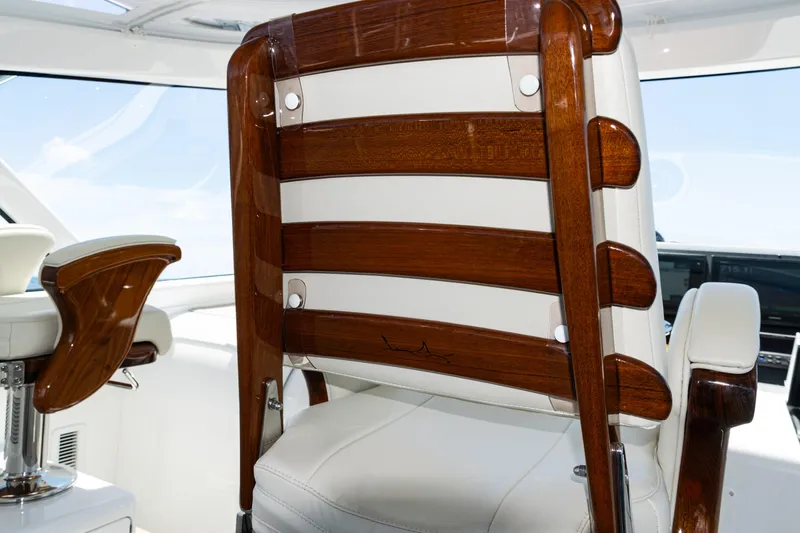 Slide: The Image of Luxury seating on 2021 Viking 44 Open yacht, featuring elegant wood and white upholstery. - 63