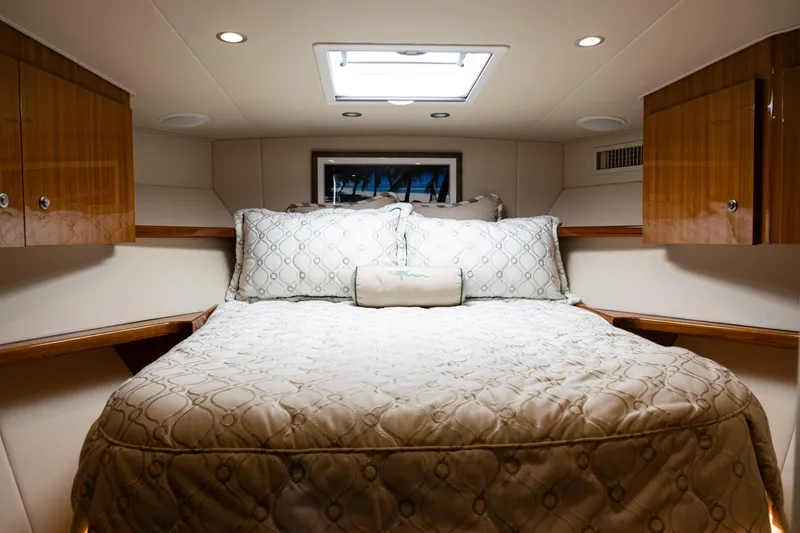 Slide: The Image of Luxurious cabin interior of 2021 Viking 44 Open yacht with cozy bedding and wooden cabinets. - 64