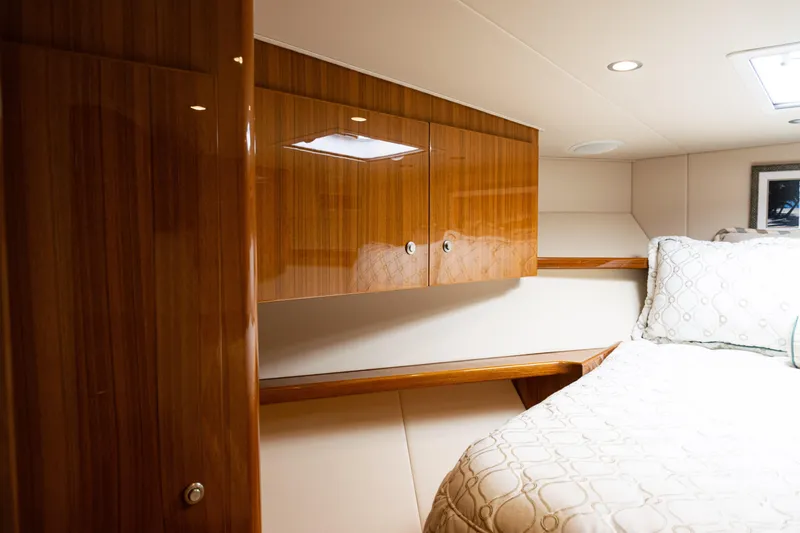 Slide: The Image of Luxurious cabin interior of 2021 Viking 44 Open yacht with wood cabinetry and cozy bedding. - 66