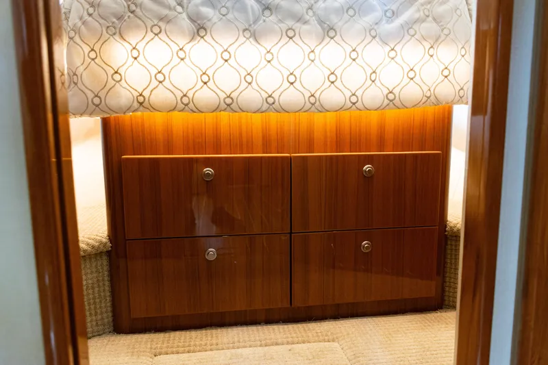 Slide: The Image of 2021 Viking 44 Open yacht interior with elegant wood cabinetry and soft lighting. - 69