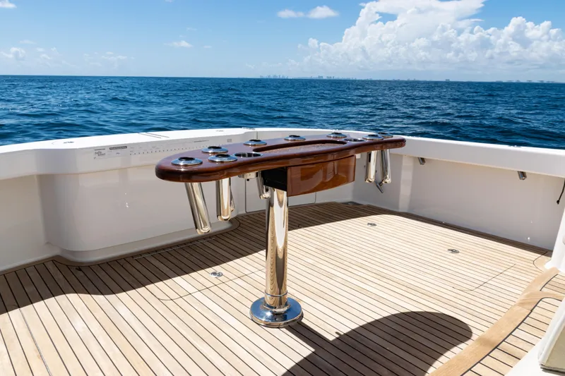 Slide: The Image of 2021 Viking 44 Open yacht deck with rod holders, overlooking the ocean. - 7
