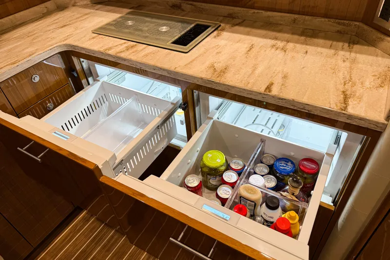 Slide: The Image of 2021 Viking 44 Open yacht kitchen with open storage drawers and countertop. - 72
