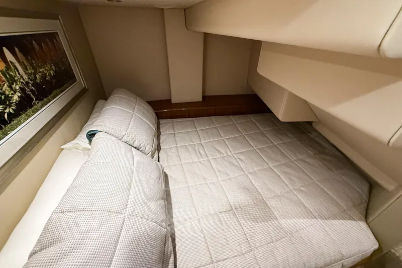 Slide: The Image of 2021 Viking 44 Open yacht cabin with cozy bedding and elegant decor. - 74