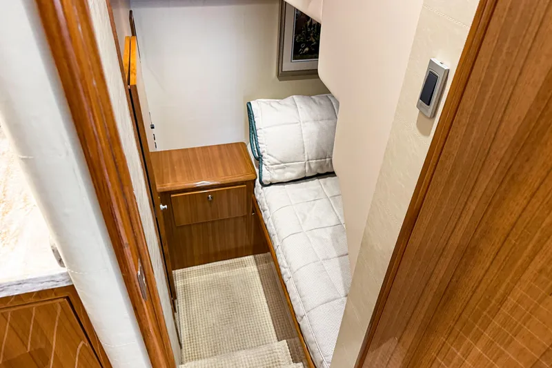 Slide: The Image of 2021 Viking 44 Open yacht interior with cozy bunk bed and wooden cabinetry. - 76