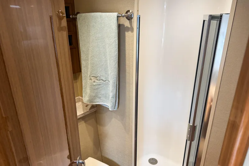 Slide: The Image of 2021 Viking 44 Open yacht bathroom with shower and towel rack. - 78