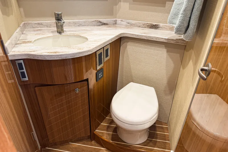 Slide: The Image of 2021 Viking 44 Open yacht bathroom with modern sink and toilet. - 80