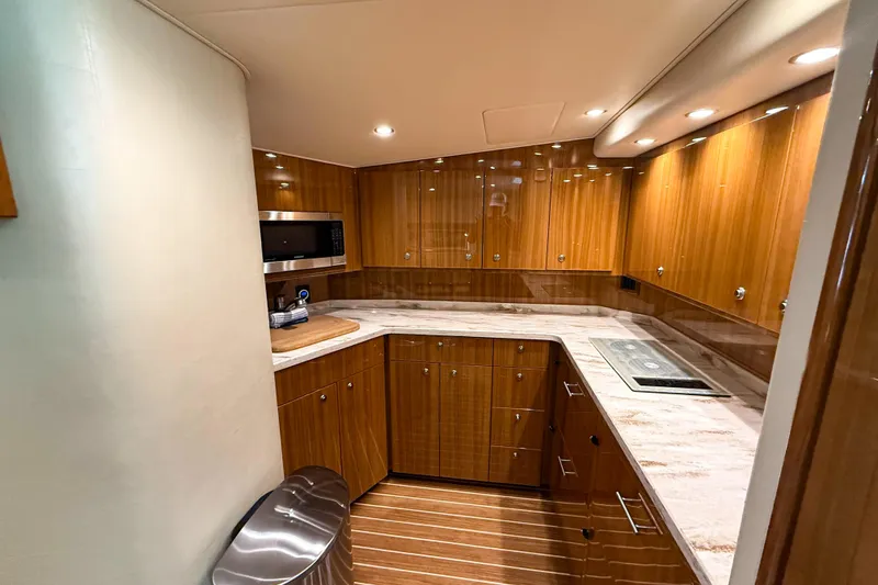 Slide: The Image of Luxurious kitchen interior of 2021 Viking 44 Open yacht with modern appliances and wood finish. - 81